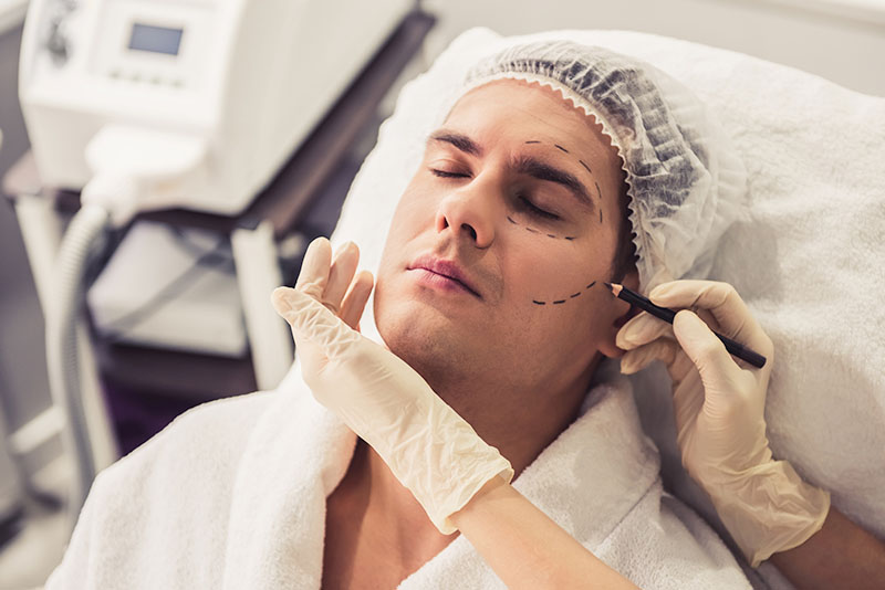 Photo of a man getting cosmetic surgery consultation.